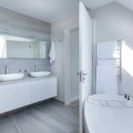 Los angeles bathroom remodel with all-white bathroom with a tub and twin sinks